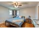 Bedroom featuring wood floors, a ceiling fan, and two windows at 598 Collier St, Columbus, IN 47201