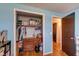 Bedroom closet with blue walls includes built in dresser and storage, and closet organizer at 598 Collier St, Columbus, IN 47201