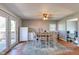 Bright dining area with wood floors and easy access to outdoor deck through glass patio doors at 598 Collier St, Columbus, IN 47201