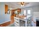 Cozy dining area featuring wood floors, a ceiling fan, and access to the outdoor patio at 598 Collier St, Columbus, IN 47201