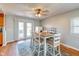 Bright dining area with access to the backyard, wood table, and a ceiling fan at 598 Collier St, Columbus, IN 47201