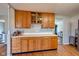 Kitchen featuring wood cabinets, white countertops, and an open view to the living area at 598 Collier St, Columbus, IN 47201