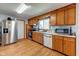 Practical kitchen with wood cabinets, stainless steel refrigerator, and ample counter space at 598 Collier St, Columbus, IN 47201