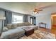 Inviting living room featuring a large sectional sofa, ceiling fan, hardwood floors and natural light at 598 Collier St, Columbus, IN 47201
