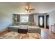 Cozy living room showcasing a large sectional sofa, ceiling fan, hardwood floors and natural light at 598 Collier St, Columbus, IN 47201