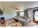 Comfortable living room featuring a large sofa, ceiling fan, hardwood floors and natural light at 598 Collier St, Columbus, IN 47201