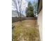Spacious backyard with a wooden fence, mature trees, a fire pit, and a patio area at 6011 Mcclellan Ct, Indianapolis, IN 46254
