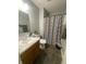 This bathroom features tile floors, a shower, a sink, and toilet at 6011 Mcclellan Ct, Indianapolis, IN 46254