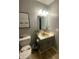 This bathroom features a sink, toilet, vanity, and tile floors at 6011 Mcclellan Ct, Indianapolis, IN 46254
