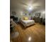 Spacious bedroom features hardwood flooring, ceiling fan, dresser, and comfortable bed at 6011 Mcclellan Ct, Indianapolis, IN 46254