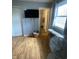 This bedroom features hardwood floors, a window, and access to the bathroom at 6011 Mcclellan Ct, Indianapolis, IN 46254