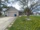Charming ranch-style home featuring a well-maintained lawn, attached garage, and inviting front porch at 6011 Mcclellan Ct, Indianapolis, IN 46254