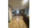 Spacious kitchen with stainless steel appliances, updated cabinets, and ample dining area seating at 6011 Mcclellan Ct, Indianapolis, IN 46254