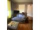 Cozy living room featuring hardwood floors, an ottoman, and comfortable seating at 6011 Mcclellan Ct, Indianapolis, IN 46254