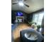Comfortable living room boasts a brick fireplace, modern TV, and sliding door to outside at 6011 Mcclellan Ct, Indianapolis, IN 46254