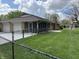 Home exterior with screened porch, stone details, garage, black fence, and a nice yard at 616 Elbow Bend Blvd, Greenwood, IN 46142