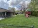 Home exterior with screened porch, stone details, black fence, and a nice playground at 616 Elbow Bend Blvd, Greenwood, IN 46142