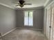 This bedroom has neutral walls, white trim, a window with sheer curtains, and a ceiling fan at 616 Elbow Bend Blvd, Greenwood, IN 46142