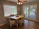 Bright dining area with a view of the fenced-in backyard and screened-in porch at 616 Elbow Bend Blvd, Greenwood, IN 46142
