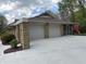 A two car garage with stone pillars and a screened in porch add unique architectural features to this home at 616 Elbow Bend Blvd, Greenwood, IN 46142
