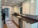 This kitchen has stainless steel appliances, custom cabinets, updated finishes, and dark countertops at 616 Elbow Bend Blvd, Greenwood, IN 46142