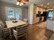 Eat-in kitchen featuring stainless steel appliances, cabinets, hardwood floors, and an adjacent screened-in porch at 616 Elbow Bend Blvd, Greenwood, IN 46142