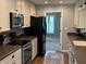 This kitchen has stainless steel appliances, custom cabinets, updated finishes, and dark countertops at 616 Elbow Bend Blvd, Greenwood, IN 46142