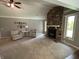 Cozy living room featuring a stone fireplace, vaulted ceilings, and natural light at 616 Elbow Bend Blvd, Greenwood, IN 46142