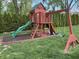 Wooden playset featuring a slide, swings, ladder, and a small playhouse at 616 Elbow Bend Blvd, Greenwood, IN 46142