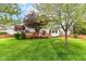 Well manicured lawn and backyard, with deck and stained wood fence at 6164 Parrington Dr, Indianapolis, IN 46236