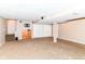 Finished basement featuring carpeting and a structural support column, with bright ceiling lights and stair access at 6164 Parrington Dr, Indianapolis, IN 46236