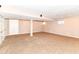 Finished basement featuring carpeting and a structural support column, with bright ceiling lights at 6164 Parrington Dr, Indianapolis, IN 46236