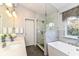 Bathroom offers dual sink vanity, soaking tub, and glass enclosed shower at 6164 Parrington Dr, Indianapolis, IN 46236