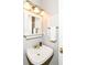 Bathroom featuring classic gold fixtures, ample lighting, and a pristine white sink at 6164 Parrington Dr, Indianapolis, IN 46236