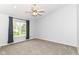 Comfortable bedroom with neutral carpeting, window views, and a ceiling fan at 6164 Parrington Dr, Indianapolis, IN 46236