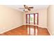 Bedroom with hardwood floors, a ceiling fan, and a bright window with neighborhood views at 6164 Parrington Dr, Indianapolis, IN 46236