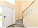 Inviting foyer featuring a staircase, tile flooring, and a bright white front door at 6164 Parrington Dr, Indianapolis, IN 46236