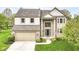 Beautiful two-story home featuring brick and siding exterior, an attached two-car garage, and manicured landscaping at 6164 Parrington Dr, Indianapolis, IN 46236