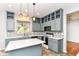 Updated kitchen with stylish lighting, an island, and ample cabinet space at 6164 Parrington Dr, Indianapolis, IN 46236