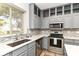 Charming kitchen featuring stainless steel appliances, countertop, and tile backsplash at 6164 Parrington Dr, Indianapolis, IN 46236