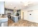 Spacious kitchen features an island with seating, stainless appliances, tiled flooring, and grey cabinets at 6164 Parrington Dr, Indianapolis, IN 46236