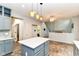 Well-lit kitchen featuring stylish countertops, island, and modern lighting fixtures at 6164 Parrington Dr, Indianapolis, IN 46236