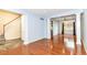 Open-concept living room with hardwood floors, decorative columns, and large windows at 6164 Parrington Dr, Indianapolis, IN 46236