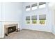Cozy living room with a brick fireplace, plush carpet, and ample natural light at 6164 Parrington Dr, Indianapolis, IN 46236