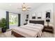 Serene main bedroom with neutral tones, large window, and ceiling fan, creating a peaceful retreat at 6164 Parrington Dr, Indianapolis, IN 46236