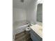 Bright bathroom with a white vanity, bathtub, and neutral-toned flooring at 621 Jack Pine Ct, Indianapolis, IN 46224