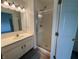 Bright bathroom with a glass-door shower, white vanity, and modern fixtures at 621 Jack Pine Ct, Indianapolis, IN 46224