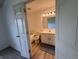 Bathroom view through an open door showing a white vanity, toilet, and tub at 621 Jack Pine Ct, Indianapolis, IN 46224