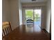 Dining room with wood table and chairs offers views of the outdoor deck and pond beyond at 621 Jack Pine Ct, Indianapolis, IN 46224