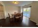 A cozy dining room with wood table and chairs, hardwood floors and a sliding glass door to the outdoor deck at 621 Jack Pine Ct, Indianapolis, IN 46224